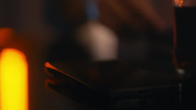 Close-up of female hands preparing narcotics for snorting in a dark room