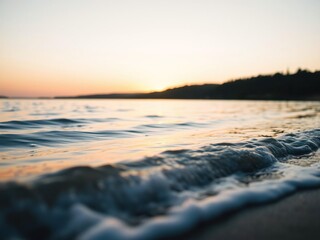 Soft focus photography of a serene lake scene with gentle waves lapping against the shore at sunset, reflective surfaces, warm tones, lake scenes
