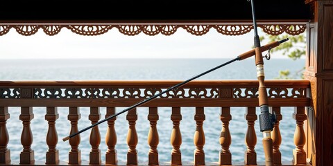 Fishing rod leaning against a luxurious wooden railing, sailing, fishing gear