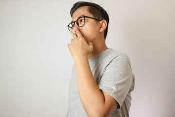 Handsome cool man with Cigarette, going to smoke, isolated on white background, copy space for advertisement. Portrait of asian man in white shirt light cigarette. copy space. Smoking concept.