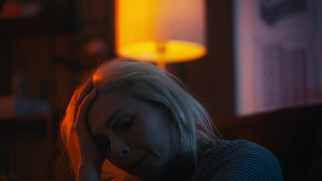 Unhappy middle-aged woman sitting on the floor, suffering depression, despair