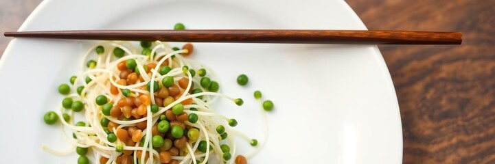 Fresh lentil sprouts arranged in a delicate pattern on a white plate with chopsticks placed beside them, fresh vegetables, healthy food