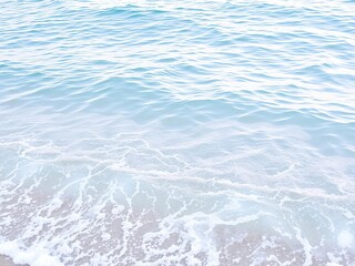 Fototapeta premium Gentle lapping of light blue waves against the shore, shoreline, ocean