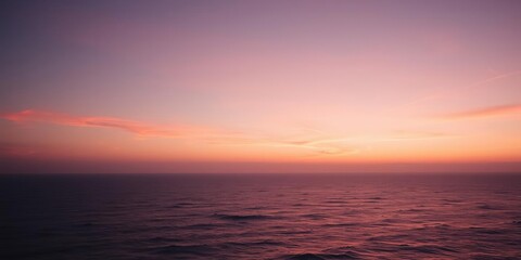 Fototapeta premium Warm golden light fades into soft pink hues as day succumbs to night over vast serene ocean, ocean, yellow, sea