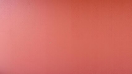 Earthy tone maroon concrete wall with a textured background featuring a mix of small and large aggregates, architectural element, cityscape