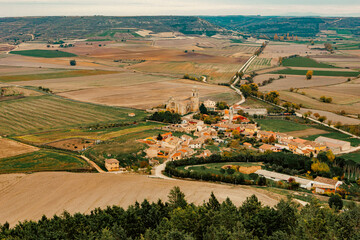 Panoramic view of Castrojeriz, Spain, as seen from the castle, surrounded by vast farmland....