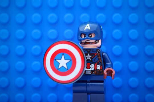 Tambov, Russian Federation - November 05, 2024 Portrait of Lego Captain America minifigure with a shield against a blue baseplate background