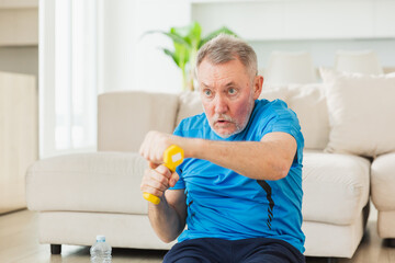 Fitness workout training. Senior man boxing punching picking up dumbbells. Old adult mature healthy man doing sports exercise at home. Grandfather have workout rehabilitation. Health care healthy