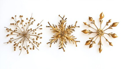 Three gold snowflakes are hanging on a white wall