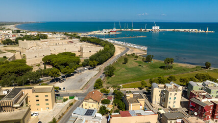 Aerial view of the castle located in Barletta, Puglia, Italy. It was a medieval fortress built on the coast of the Mediterranean Sea. Today it's a museum. In the background is the port of the town.