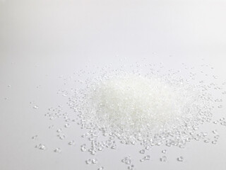 Virgin polycarbonate plastic granules on a white background, one of the main materials in the...