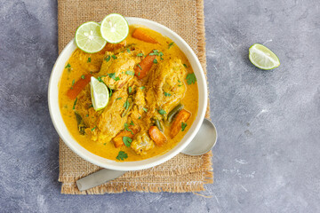 Healthy Chicken Stew with Coconut Milk Garnished with Fresh Cilantro and Lemon Top Down Healthy Food Photo
