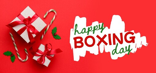 Christmas gifts and decorations on red background. Banner for Boxing Day