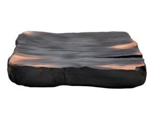 A wooden slab with a burnt edge sits on a white background. transparent background