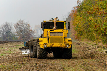 The tractor plows the land in autumn, for sowing. Image of agriculture