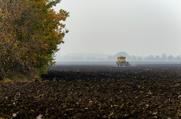The tractor plows the land in autumn, for sowing. Image of agriculture