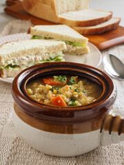 Lentil Vegetable Soup in Brown Crock with Chicken Salad Sandwich Vert
