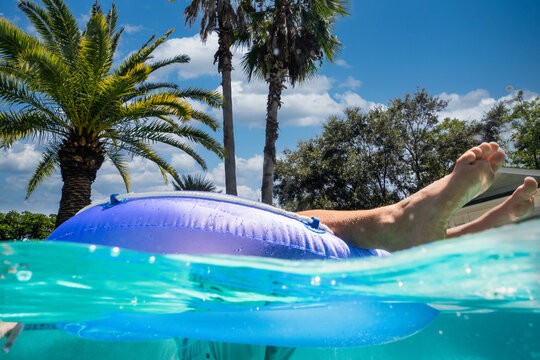 Boy floating on a pool toy 