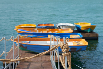 Obraz premium Pier with boats on the lake shore. Copy space.