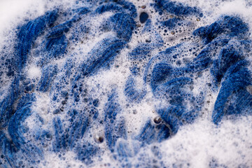 Obraz premium Blue Wool Sweater Being Hand Washed in Soapy Water