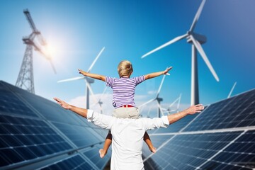 Happy young dad with child at solar panels roof