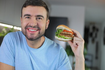 Handsome man eating a hamburger 