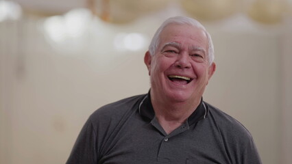 Casual Caucasian Senior Man in His 70s Laughing Spontaneously, Close-Up Smiling Face