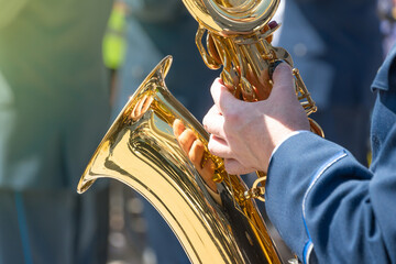 a brass musician holding a saxophone