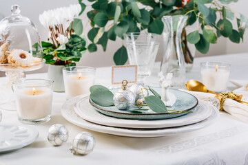 Traditional festive place setting for Christmas, decorated with eucalyptus branch