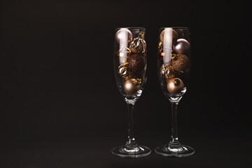 New Year composition with two glasses, decoration and lights.