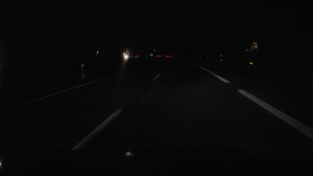 vertical video driving at night in the rain with the lights of the cars and windscreen