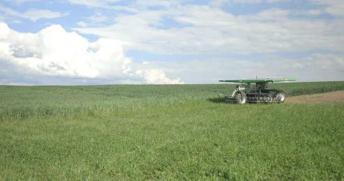 Agricultural robot farmdroid fd20 on a field in a rural scene. Blue sky with clouds. 4k video. 