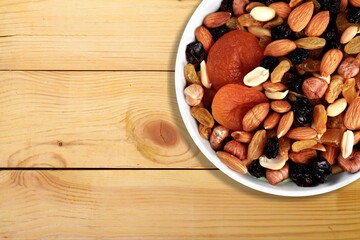 Tasty healthy mixed nuts on wooden desk
