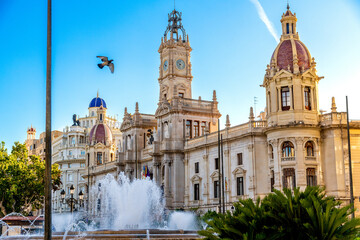 Fototapeta premium Modernisme Plaza building with baroque domes, clock tower, and fountain