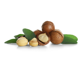 Tasty macadamia nuts and leaves on white background