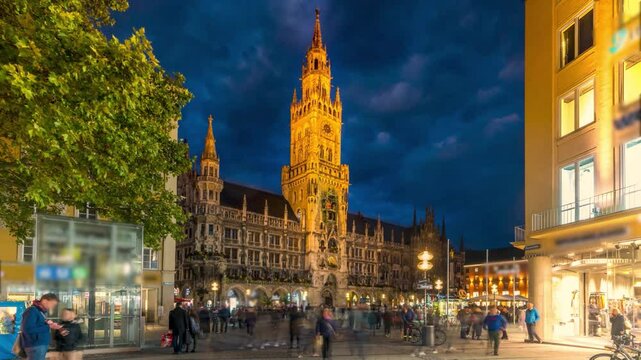 Marienplazt Old Town Square with New Town Hall day to night transition timelapse hyperlapse. Neues Rathaus and Town Hall Clock Tower Glockenspiel. Munich skyline, downtown cityscape. Bavaria, Germany
