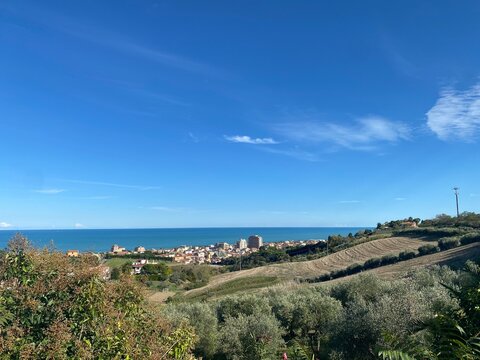 Scenic view of green hills descending to the adriatic sea near Tortoreto, abruzzo, italy, against a picturesque blue sky with scattered clouds