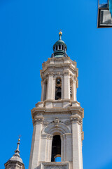 Close-up of bell tower with baroque details and green dome