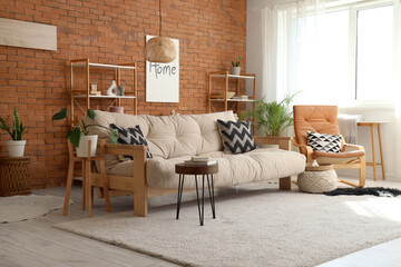 Interior of living room with couch, armchair and shelf units