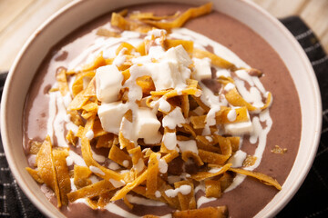 Creamy bean soup. In Mexico known as Crema de Frijoles, a very easy and nutritious homemade food recipe, commonly accompanied with cheese, cream, avocado and corn tortilla cut into strips and fried.