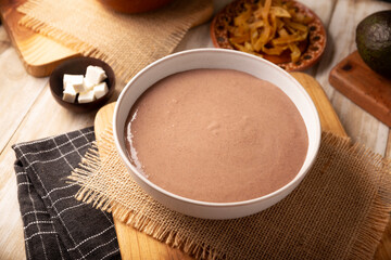 Creamy bean soup. In Mexico known as Crema de Frijoles, a very easy and nutritious homemade food recipe, commonly accompanied with cheese, cream, avocado and corn tortilla cut into strips and fried.