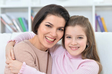 Little girl with her mother posing at home