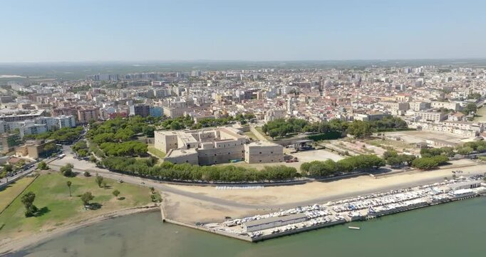 Aerial view of the castle located in Barletta, Puglia, Italy. It was a medieval fortress and today it is a museum. In background is the Basilica of Santa Maria Maggiore, cathedral of the town.