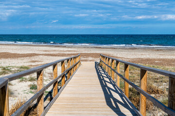 Wooden Pathway Leading to a Serene Beach and Ocean