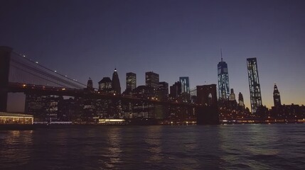 Obraz premium Night View of City Skyline with Bridge Silhouette