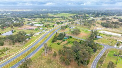 Drone aerial photograph of a multi lane road system running through a large agricultural area in the regional township of Luddenham in New South Wales, Australia.