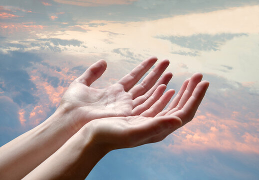 The outstretched hands of a praying man