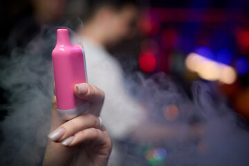 Exploring Vaping Culture A Vape Device in Action Surrounded by Colorful Vapor Clouds