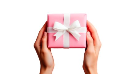 Close-up of top view of female hands holding gift wrapped in pink paper with a white bow on a transparent background  