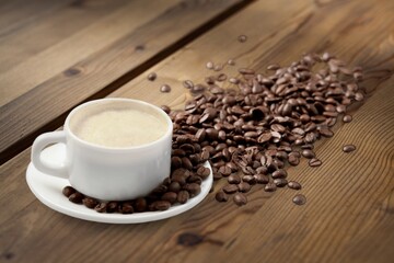 Coffee cup and beans on  desk background